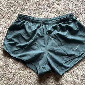 Nike Dri-Fit size large running shorts with built in briefs. Greenish in color.